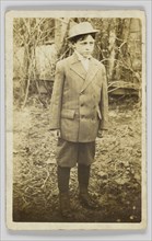Photographic postcard of a boy wearing a double-breasted jacket and breeches, early 20th century. Creator: Unknown.