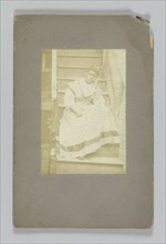 Albumen print of an unidentified woman sitting on stairs, 1850-1895. Creator: Unknown.