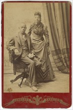 Photograph of African-American man and woman in formal clothes, late 19th century. Creator: Louis Janousek.
