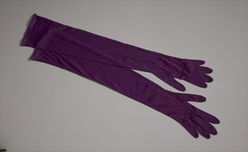 Pair of arm length purple gloves from Mae's Millinery Shop, 1941-1994. Creator: Van Raalte.