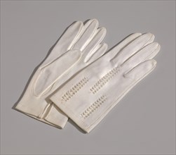 Pair of light cream gloves with openwork design from Mae's Millinery Shop, 1941-1994. Creator: Van Raalte.