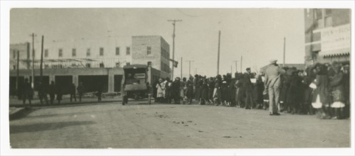 Photograph of people standing in a line on a street in Tulsa, Oklahoma, ca. 1920. Creator: Unknown.