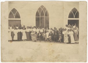 Photographic print of men and women in front of Vernon AME Church, Tulsa, ca. 1919. Creator: Unknown.
