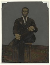 Tintype of a man wearing a suit with a pendant on the lapel, early 20th century. Creator: Unknown.
