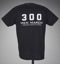 Black t-shirt for 300 Men March worn at a rally after the death of Freddie Gray, 2015. Creator: Gildan Activewear Inc..