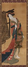A courtesan standing near a clothes rack, Edo period, early 19th century. Creator: Hishikawa Sori.