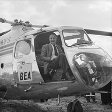 Artist Terence Cuneo in a BEA helicopter, London to Yorkshire Motorway, 10/1958. Creator: John Laing plc.