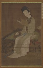Young woman reading a book of poems, Ming dynasty, 16th-17th century. Creator: Unknown.