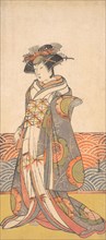 The Third Segawa Kikunojo as a Woman Standing in a Room Having a Wave-pattern Dado, ca. 1779. Creator: Shunsho.
