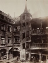 Untitled [courtyard with balconies and spiral staircase], 1870s.  Creator: Unknown.