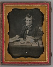 Untitled (Portrait of Seated Man Holding a Daguerreotype and Brush), 1865. Creator: Samuel J. Miller.