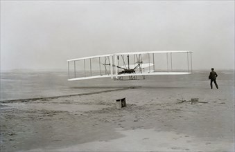 First flight of Wright brothers aircraft, Kitty Hawk, North Carolina, USA, December 17, 1903.  Creator: Unknown.