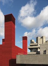 Royal National Theatre, Upper Ground, Southwark, London, 2014. General view of the tops of the red-painted wooden temporary theatre and the concrete Royal National Theatre building, from the south-wes...