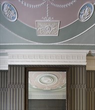 Decorative Adam style plasterwork in a Georgian town house, Portland Place, London, 2014. Detail of decorative plasterwork in the town house's ground-floor back room, more of which is seen in reflecti...