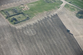 A round barrow showing as a soilmark in a freshly ploughed field near West Overton, Wiltshire, 2015.
