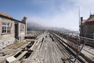 Birnbeck Pier, Birnbeck Island, Weston-Super-Mare, Somerset, 2018. General view looking south-east along the pier, showing its derelict walkway and decaying timbers.