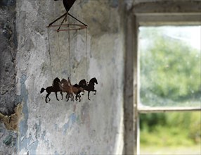 Bunksland Farmhouse, East Anstey, Devon, 2018. Detail of a mobile comprising silhouettes of horses, hanging from the ceiling in the farmhouse's ground-floor room, 2018.