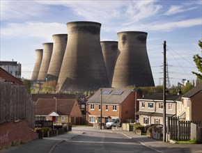 Ferrybridge C Power Station, West Yorkshire, 2018. General view looking north-west along a suburban street, with the power station's cooling towers dominating the skyline behind.