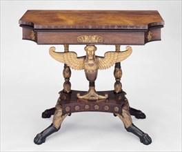 Card Table, c. 1815. Mahogany with rosewood veneer, giltwood, brass and ebony inlay, winged caryatid central support.
