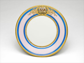 Illinois Plate, c. 1878/89. Porcelain plate painted with gold, filigree-patterned cartouche, bald eagle with the Illinois state motto, 'State Sovereignty, National Union'. Decorated by Joseph S. Potte...