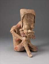 Seated Figure with an Elongated Head and Chin Placed on Knee, 300 B.C./A.D. 300.