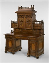 Desk and Bookcase, 1893. Decorative carved 'roof', and panels with portraits.