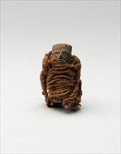 Mold-Made Figurine Wrapped in Wool String, A.D. 100/600.