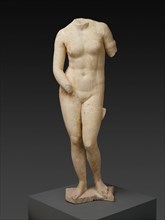 Statue of the Aphrodite of Knidos, 2nd century. White and beige stone statue of a female nude standing in contrapposto position, with weight on the right leg. The head of the statue is missing. The le...