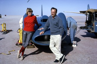 Donald Campbell with his wife Tonia and Bluebird CN7, Lake Eyre, Australia, 1964. Creator: Unknown.