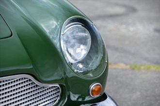 Left front headlight of a 1961 Aston Martin DB4 GT previously owned by Donald Campbell. Creator: Unknown.