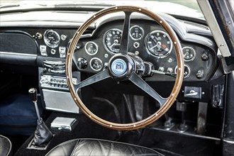 Steering wheel and dashboard of a 1965 Aston Martin DB5. Creator: Unknown.