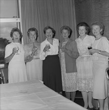 Women with celebratory drinks at the retirement presentation of Mary Coldicott, 01/08/1986. Creator: John Laing plc.