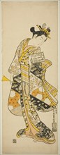 Standing Geisha, c. 1748. Woman on her way to her a music lesson. She holds a practice book for a narrative musical (joruri), and a plectrum (bachi) for playing the shamisen.