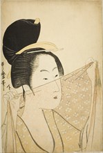 Woman Holding up a Piece of Fabric (Nuno o kazasu onna), Japan, c. 1795/96.