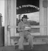 Man in front of post office, Carey, Texas, 1937. Creator: Dorothea Lange.