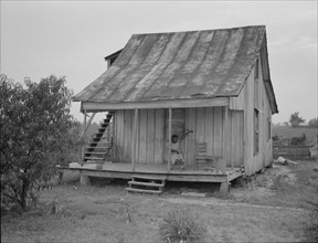 Cotton field hand sitting on her porch on Sunday afternoon, near Blytheville, Arkansas, 1937. Creator: Dorothea Lange.