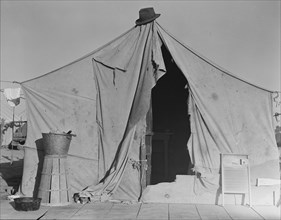 One of a row of tents, home of a pea picker, near Calipatria, Imperial Valley, CA, 1939. Creator: Dorothea Lange.
