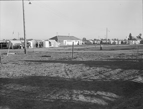 Migratory labor camp during pea harvest, FSA, Brawley, Imperial Valley, California , 1939. Creator: Dorothea Lange.
