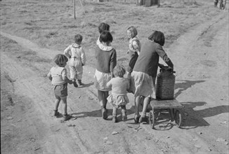 Children of migratory workers, hauling water, American River camp, San Joaquin Valley, CA, 1936. Creator: Dorothea Lange.