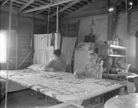 Grandmother from Oklahoma with grandson, working on quilt, California, Kern County, 1936. Creator: Dorothea Lange.