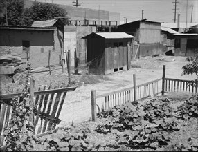 Homes of Mexican field laborers, a street in Brawley, Imperial Valley, California, 1935. Creator: Dorothea Lange.