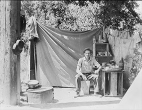 Jack Neill, "migratory fruit tramp," on banks of Pulah Creek near Winters, California, 1935. Creator: Dorothea Lange.