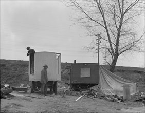 A new home on wheels (father and son), Yuba County, California, 1935. Creator: Dorothea Lange.