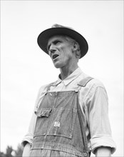 J.M. Rees tells his story of violence in Arkansas, Hill House, Mississippi, 1936. Creator: Dorothea Lange.