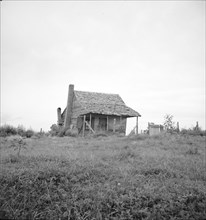Many cabins of this type are found on the Mississippi Delta, 1936. Creator: Dorothea Lange.
