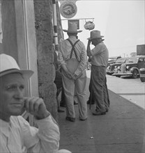 Farmers on main street discussing drought, Sallisaw, Sequoyah County, Oklahoma, 1936. Creator: Dorothea Lange.