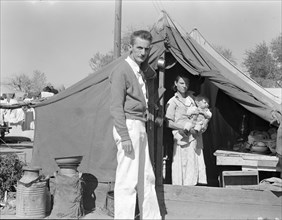 Tom Collins, manager of Kern migrant camp, California, with migrant mother and child, 1936. Creator: Dorothea Lange.