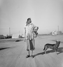 Cotton picker on her way to the cotton field, Kern migrant camp, California, 1936. Creator: Dorothea Lange.