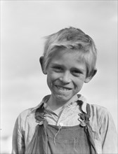 Son of cotton picker living in squatters' camp near Farmersville, California, 1936. Creator: Dorothea Lange.