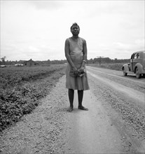 Negro woman carrying her shoes home..., Mississippi Delta, 1936. Creator: Dorothea Lange.